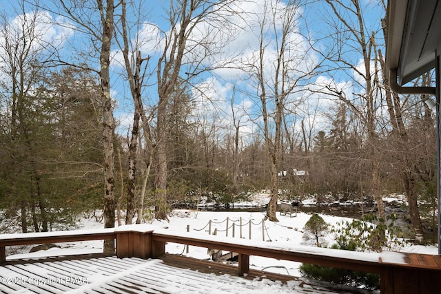 yard layered in snow featuring a deck