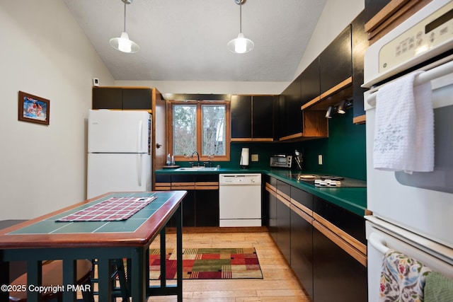 2222 Hillcrest Dr, Pocono Pines, PA 18350 - kitchen with a sink, dark countertops, white appliances, light wood finished floors, and lofted ceiling