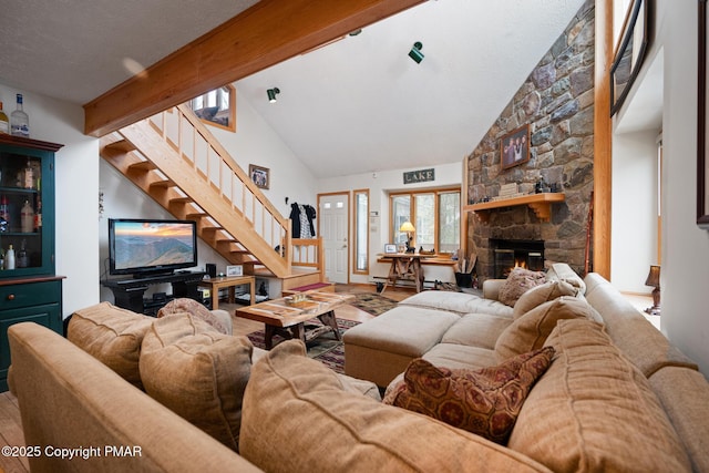 2222 Hillcrest Dr, Pocono Pines, PA 18350 - living room featuring wood finished floors, high vaulted ceiling, beam ceiling, stairs, and a stone fireplace