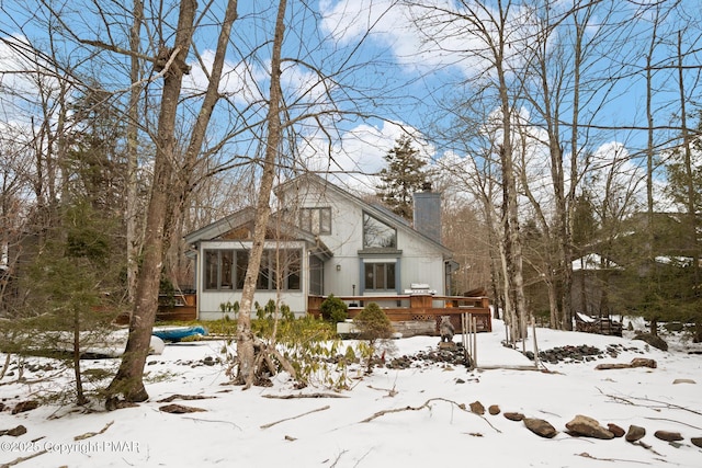 2222 Hillcrest Dr, Pocono Pines, PA 18350 - exterior space featuring a chimney, a deck, and a sunroom
