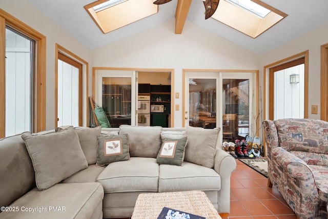 living area featuring tile patterned flooring and lofted ceiling with skylight