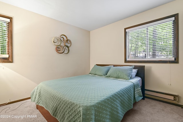 carpeted bedroom featuring a baseboard radiator and baseboards