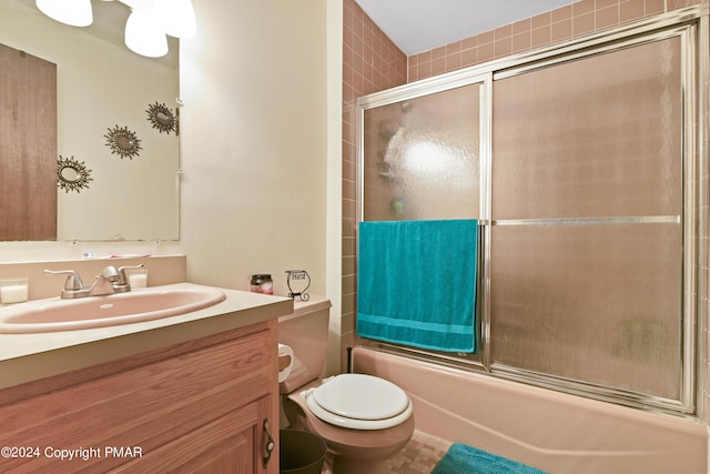 full bathroom featuring enclosed tub / shower combo, toilet, and vanity