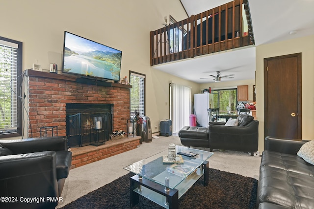 carpeted living room featuring a fireplace, a high ceiling, and a ceiling fan