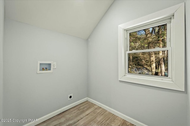 clothes washing area with hookup for a washing machine, light hardwood / wood-style flooring, and hookup for an electric dryer