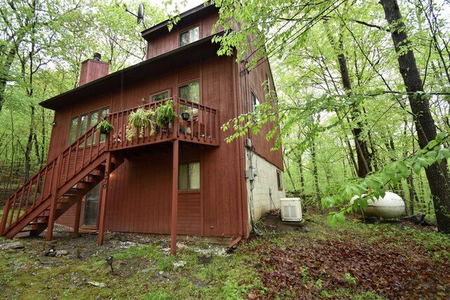158 Saunders Dr, Bushkill, PA 18324 - back of property featuring stairs, a chimney, and a deck