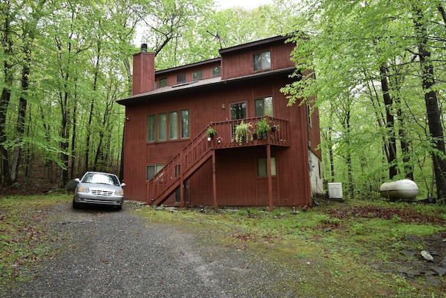 158 Saunders Dr, Bushkill, PA 18324 - view of front facade with a chimney, stairway, and a wooden deck