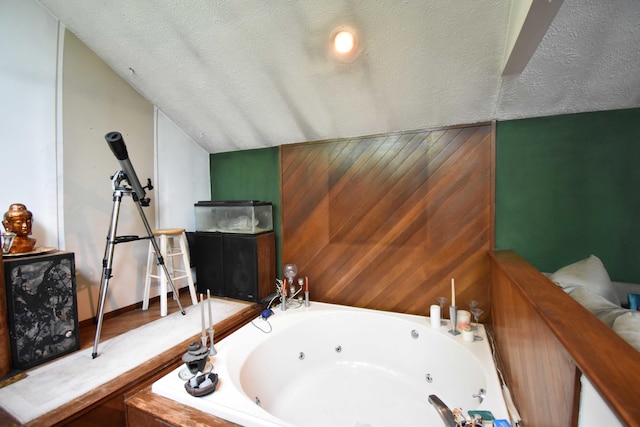 158 Saunders Dr, Bushkill, PA 18324 - bathroom with a whirlpool tub, a textured ceiling, and vaulted ceiling