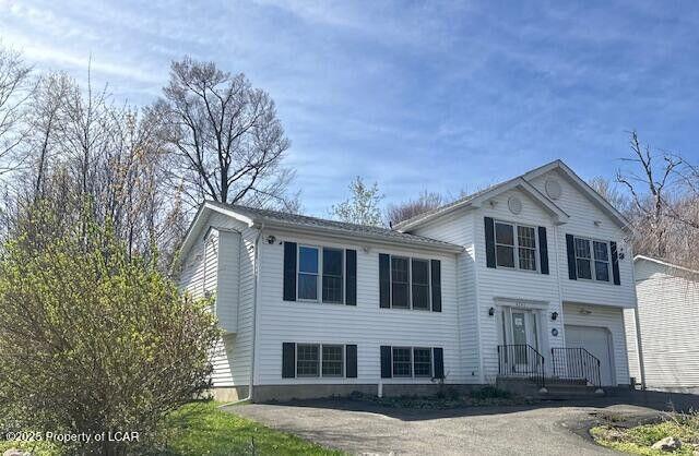 2114 Freedom Way, Pocono Summit, PA 18346 - split level home featuring a garage and asphalt driveway