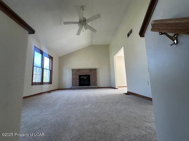 2114 Freedom Way, Pocono Summit, PA 18346 - unfurnished living room featuring lofted ceiling, ceiling fan, carpet floors, baseboards, and a brick fireplace