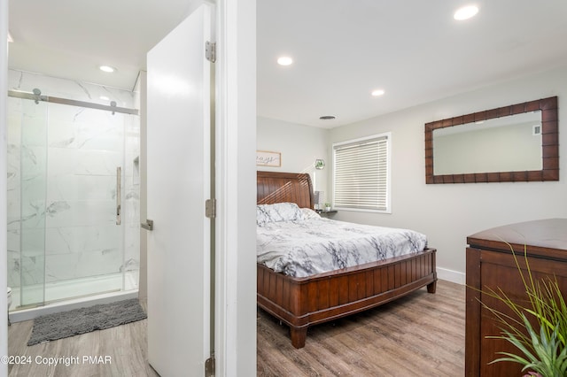 bedroom featuring ensuite bathroom, baseboards, wood finished floors, and recessed lighting