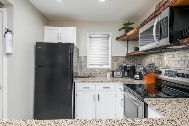 kitchen featuring open shelves, white cabinetry, stainless steel appliances, and decorative backsplash