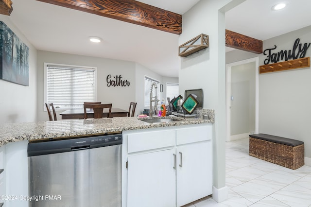 kitchen with marble finish floor, white cabinets, a sink, light stone countertops, and dishwasher