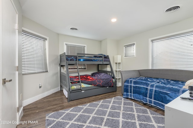 bedroom with recessed lighting, wood finished floors, visible vents, and baseboards