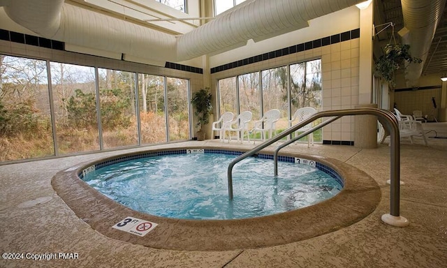 view of pool featuring an indoor hot tub and a patio area