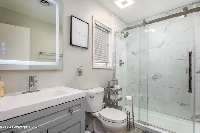 bathroom with toilet, vanity, a marble finish shower, and visible vents