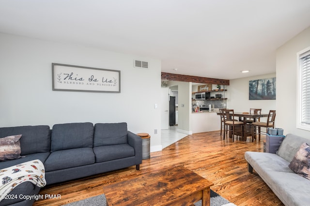 living room with visible vents and wood finished floors