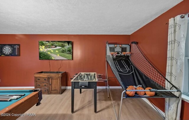 playroom featuring billiards, a textured ceiling, baseboards, and wood finished floors