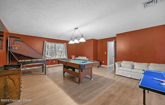 rec room with a textured ceiling, pool table, wood finished floors, and visible vents