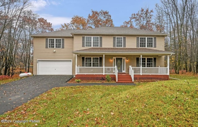 view of front facade with a porch, a front lawn, a garage, and aphalt driveway