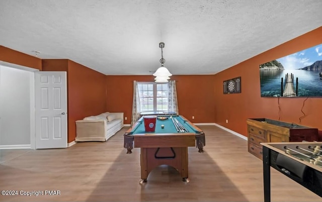 recreation room with billiards, a textured ceiling, wood finished floors, and baseboards