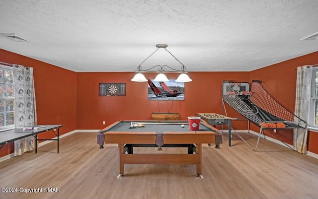 playroom with visible vents, a textured ceiling, and wood finished floors