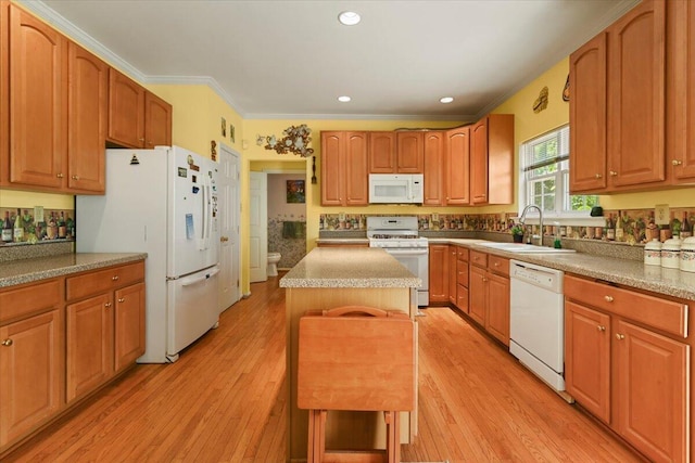 2358 Snapdragon Pt, East Stroudsburg, PA 18301 - kitchen featuring white appliances, light wood finished floors, a kitchen island, crown molding, and recessed lighting