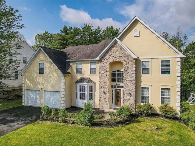 2358 Snapdragon Pt, East Stroudsburg, PA 18301 - traditional-style home with stucco siding, stone siding, driveway, a garage, and a front lawn