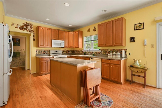 2358 Snapdragon Pt, East Stroudsburg, PA 18301 - kitchen featuring white appliances, light wood-style flooring, ornamental molding, a center island, and recessed lighting