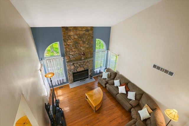 2358 Snapdragon Pt, East Stroudsburg, PA 18301 - living area with wood finished floors, a stone fireplace, and a towering ceiling