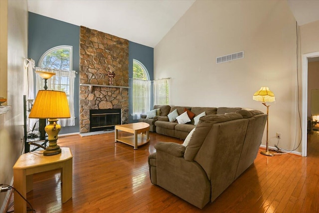 2358 Snapdragon Pt, East Stroudsburg, PA 18301 - living room with high vaulted ceiling, wood-type flooring, healthy amount of natural light, and a fireplace