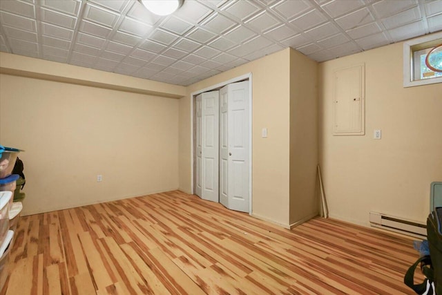 2358 Snapdragon Pt, East Stroudsburg, PA 18301 - unfurnished bedroom with a baseboard heating unit, light wood-style flooring, a closet, and electric panel