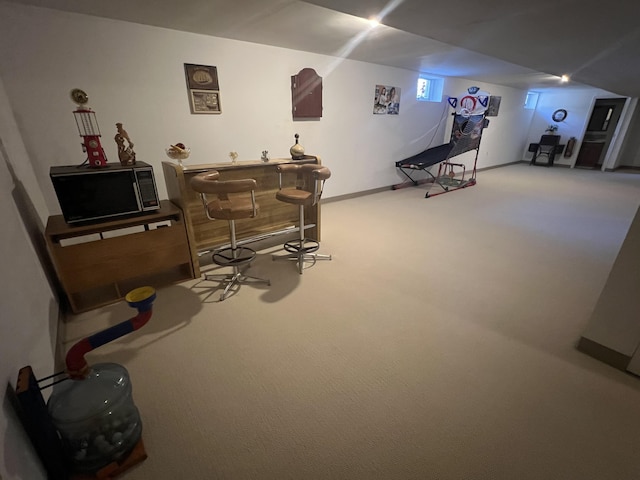 game room featuring baseboards, carpet, and a dry bar