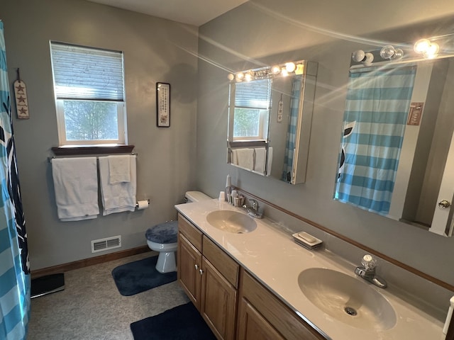 full bathroom featuring visible vents, a healthy amount of sunlight, and a sink