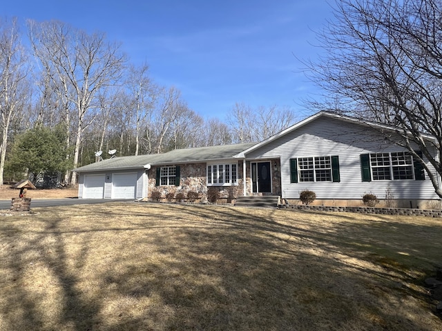 single story home with an attached garage, driveway, and a front lawn