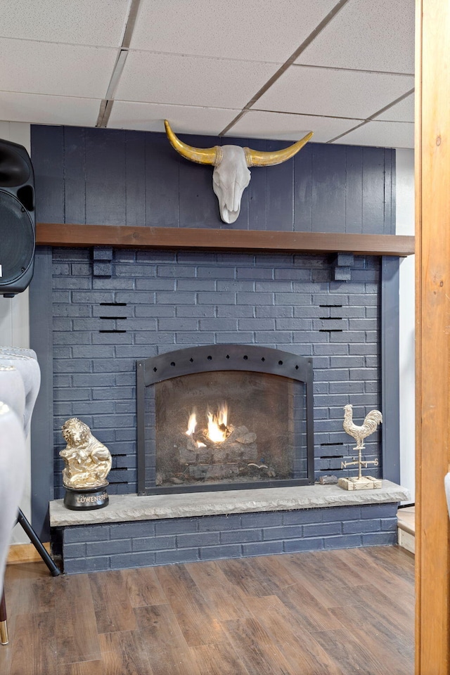 7 Park Ln, Lake Harmony, PA 18624 - detailed view of a paneled ceiling, a lit fireplace, and wood finished floors