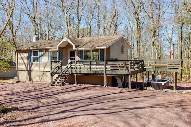 7 Park Ln, Lake Harmony, PA 18624 - view of front facade with a chimney, covered porch, and a deck