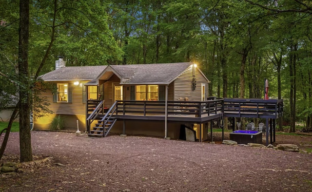 7 Park Ln, Lake Harmony, PA 18624 - chalet / cabin with a chimney, a deck, a shingled roof, and stairway