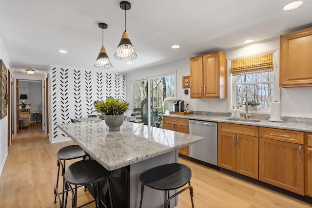 7 Park Ln, Lake Harmony, PA 18624 - kitchen featuring stainless steel dishwasher, a sink, a breakfast bar area, light stone countertops, and a kitchen island