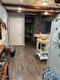 interior space featuring beam ceiling and wood finished floors