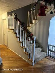 staircase with wood finished floors