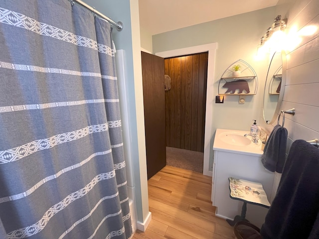 bathroom with wood finished floors and vanity