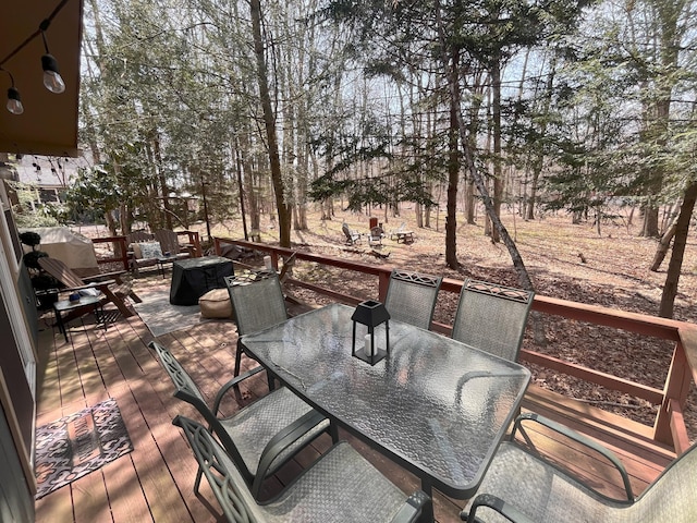 deck featuring a fire pit and outdoor dining space