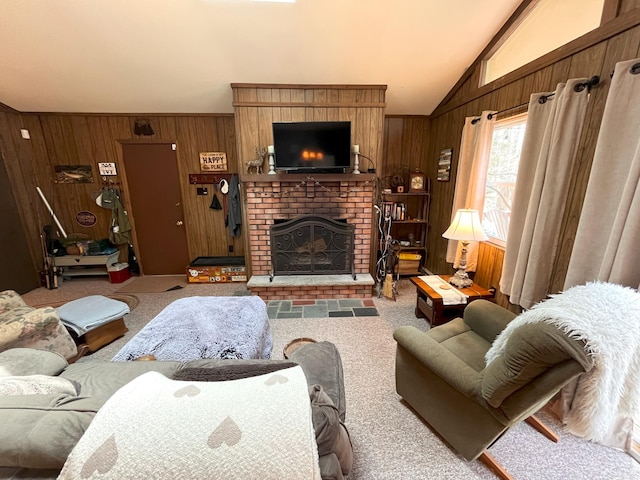 carpeted living room featuring lofted ceiling, wooden walls, and a fireplace
