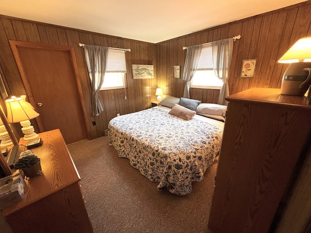 bedroom with wood walls and carpet
