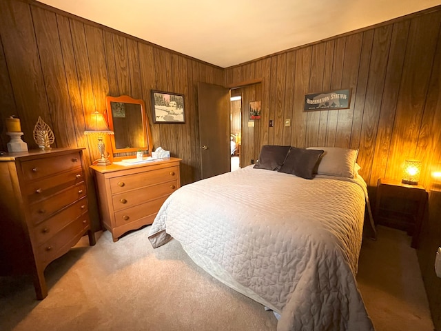 bedroom with wood walls and light colored carpet