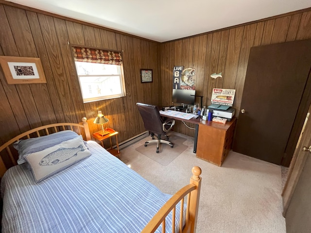 carpeted bedroom with a baseboard heating unit and wooden walls