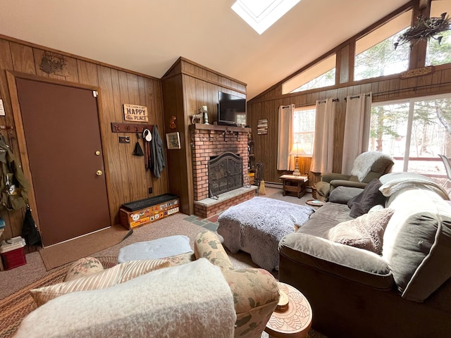 living room with a fireplace, wood walls, carpet floors, a baseboard radiator, and lofted ceiling with skylight