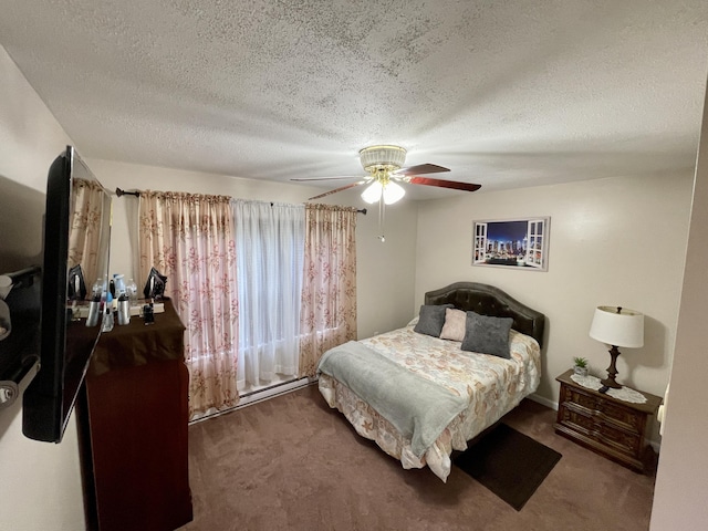 carpeted bedroom with a textured ceiling and a ceiling fan