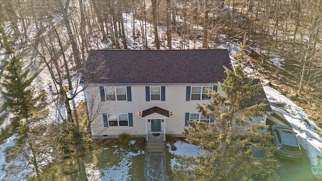 colonial home with roof with shingles and crawl space